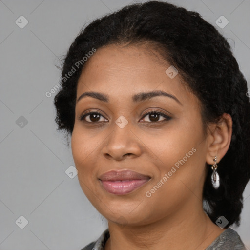 Joyful black young-adult female with long  black hair and brown eyes