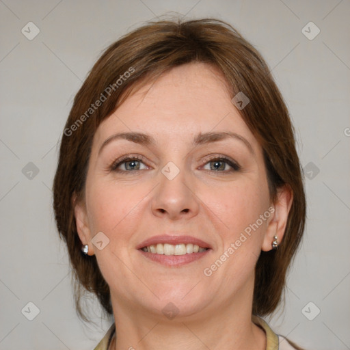 Joyful white adult female with medium  brown hair and grey eyes