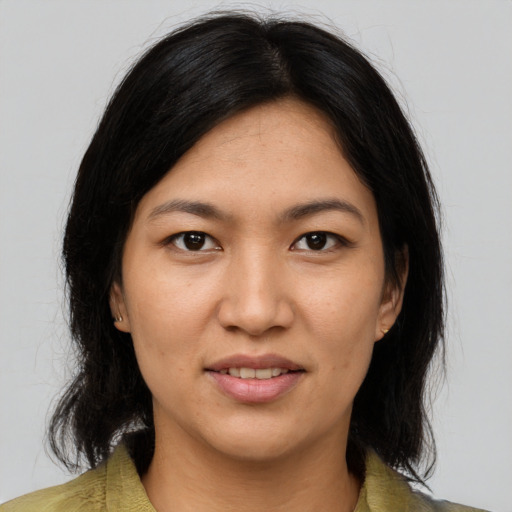 Joyful asian young-adult female with medium  brown hair and brown eyes