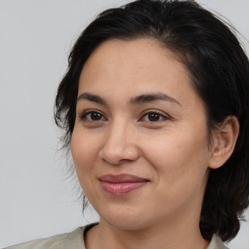 Joyful white adult female with medium  brown hair and brown eyes