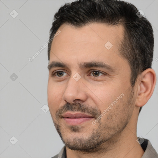 Joyful white adult male with short  black hair and brown eyes