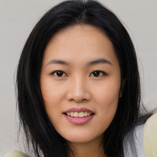 Joyful asian young-adult female with long  black hair and brown eyes