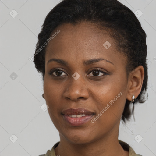 Joyful black young-adult female with short  brown hair and brown eyes