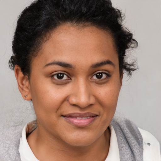 Joyful latino young-adult female with short  brown hair and brown eyes