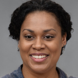 Joyful black adult female with short  brown hair and brown eyes