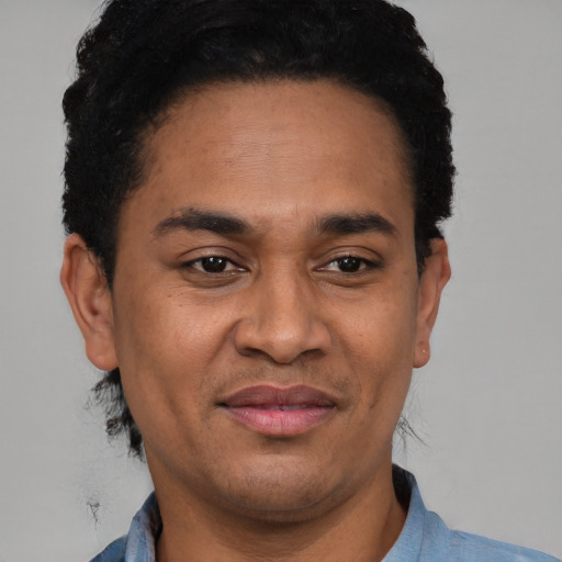 Joyful latino adult male with short  black hair and brown eyes