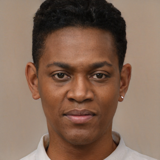 Joyful black young-adult male with short  black hair and brown eyes