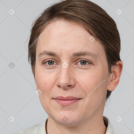 Joyful white adult female with short  brown hair and grey eyes