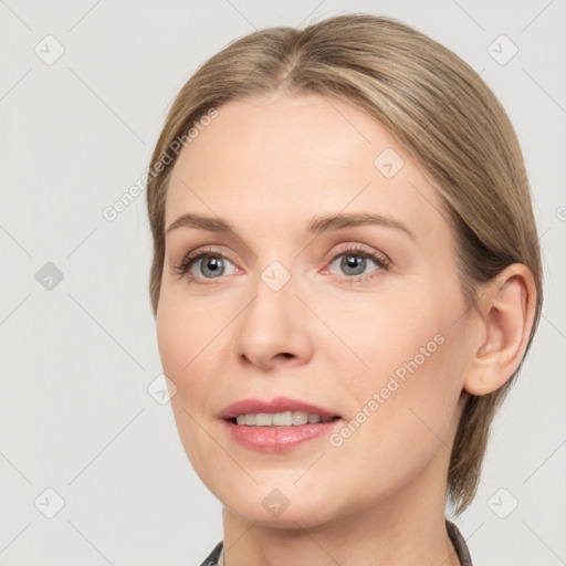 Joyful white young-adult female with medium  brown hair and grey eyes