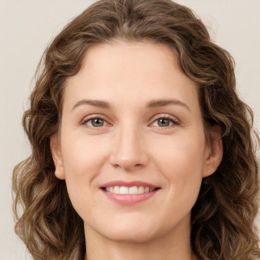 Joyful white young-adult female with long  brown hair and green eyes