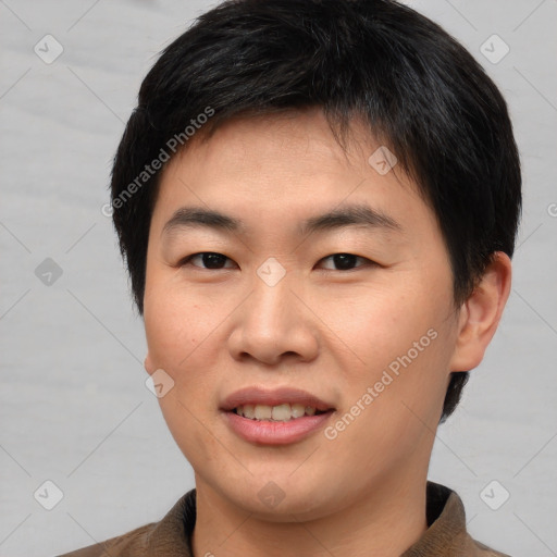 Joyful asian young-adult male with short  brown hair and brown eyes