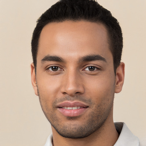 Joyful white young-adult male with short  black hair and brown eyes