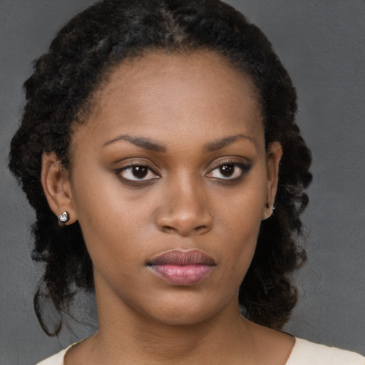 Neutral black young-adult female with medium  brown hair and brown eyes