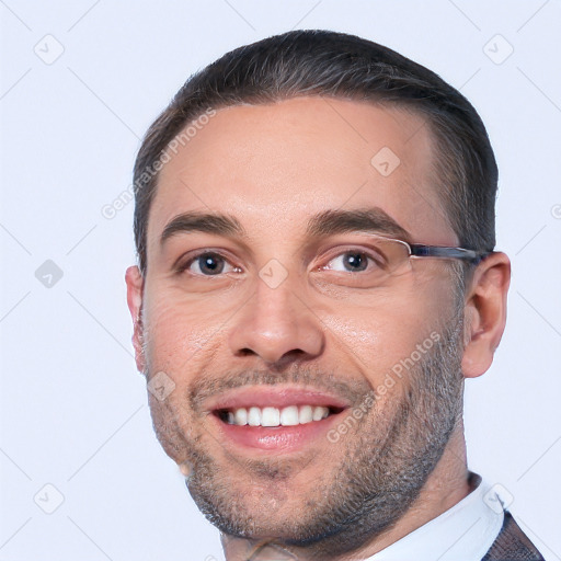 Joyful white young-adult male with short  black hair and brown eyes