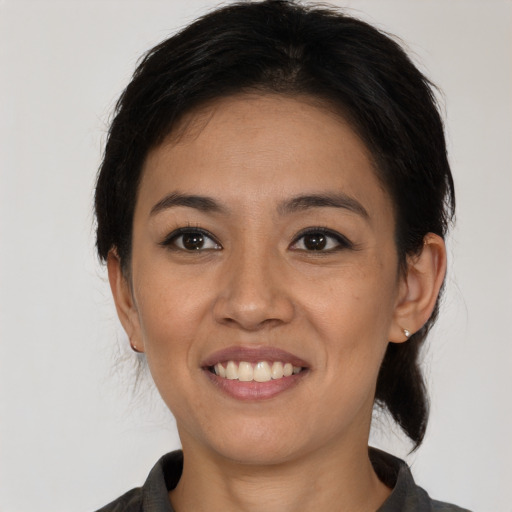 Joyful asian young-adult female with medium  black hair and brown eyes