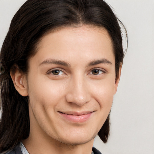 Joyful white young-adult female with long  brown hair and brown eyes