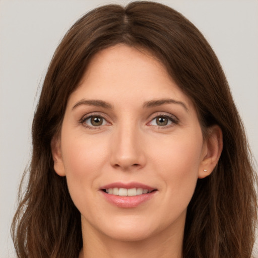 Joyful white young-adult female with long  brown hair and brown eyes