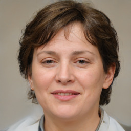 Joyful white adult female with medium  brown hair and brown eyes