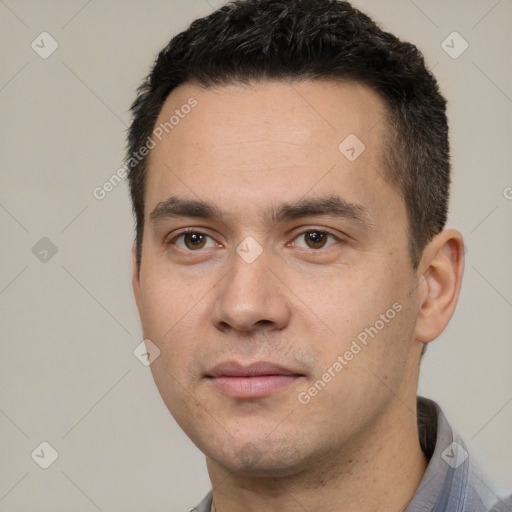 Joyful white young-adult male with short  black hair and brown eyes