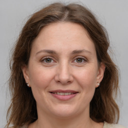 Joyful white adult female with medium  brown hair and grey eyes