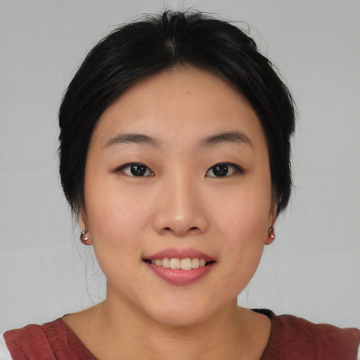 Joyful asian young-adult female with medium  black hair and brown eyes