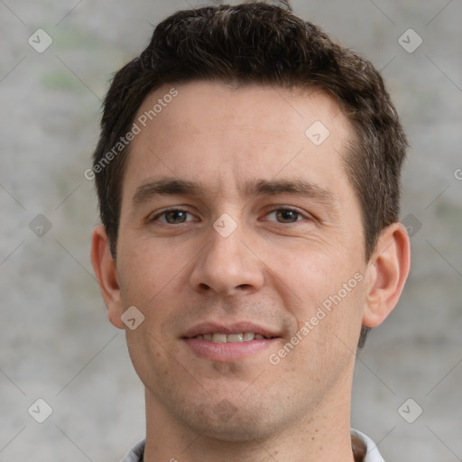 Joyful white young-adult male with short  brown hair and grey eyes