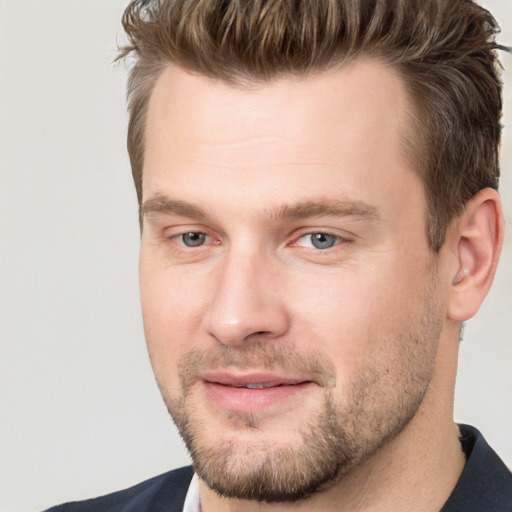 Joyful white adult male with short  brown hair and brown eyes