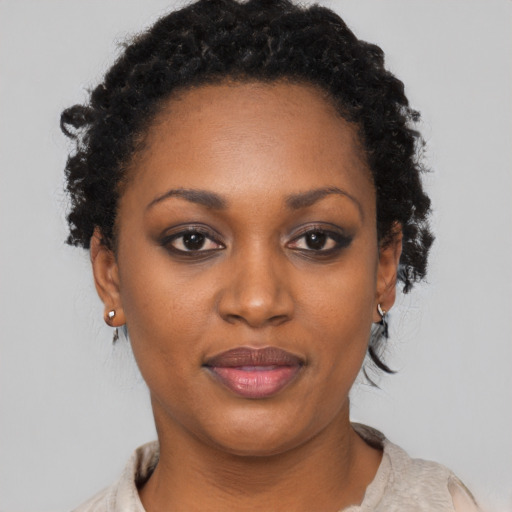 Joyful black young-adult female with short  brown hair and brown eyes