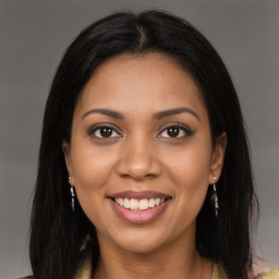 Joyful latino young-adult female with long  brown hair and brown eyes