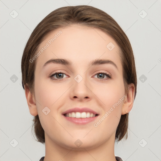 Joyful white young-adult female with medium  brown hair and green eyes