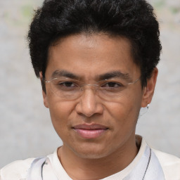 Joyful white adult male with short  black hair and brown eyes