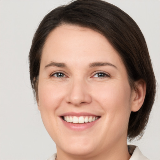 Joyful white young-adult female with medium  brown hair and brown eyes