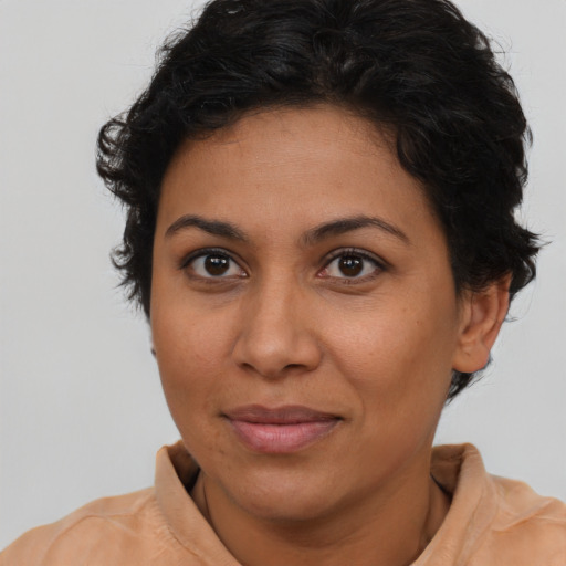 Joyful latino young-adult female with short  brown hair and brown eyes