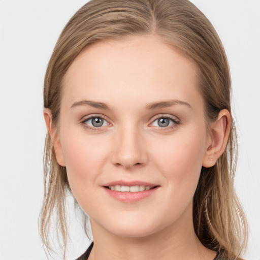 Joyful white young-adult female with long  brown hair and grey eyes