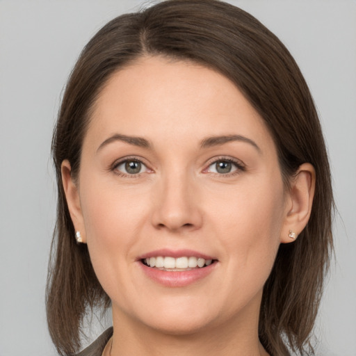 Joyful white young-adult female with medium  brown hair and brown eyes