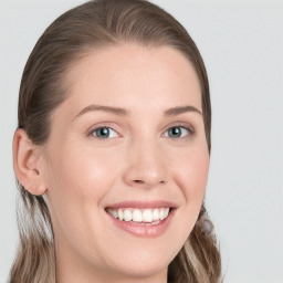 Joyful white young-adult female with long  brown hair and blue eyes