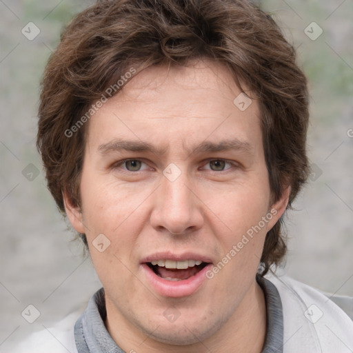 Joyful white adult male with short  brown hair and grey eyes