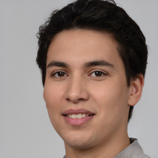 Joyful white young-adult male with short  black hair and brown eyes