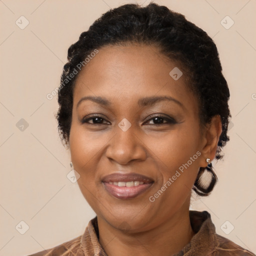 Joyful black adult female with medium  brown hair and brown eyes