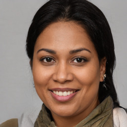 Joyful latino young-adult female with medium  brown hair and brown eyes