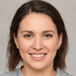 Joyful white young-adult female with medium  brown hair and grey eyes