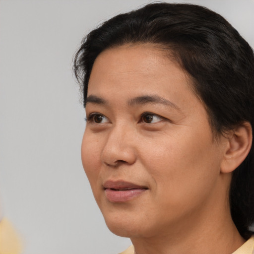 Joyful asian adult female with short  brown hair and brown eyes