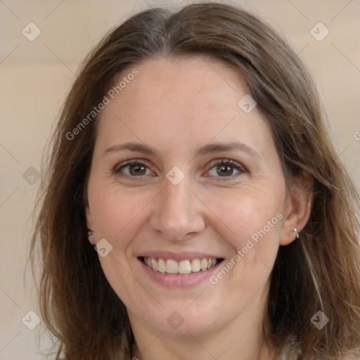 Joyful white adult female with long  brown hair and brown eyes