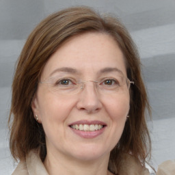 Joyful white adult female with medium  brown hair and grey eyes