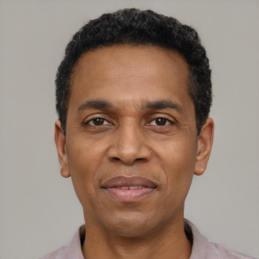 Joyful latino adult male with short  black hair and brown eyes