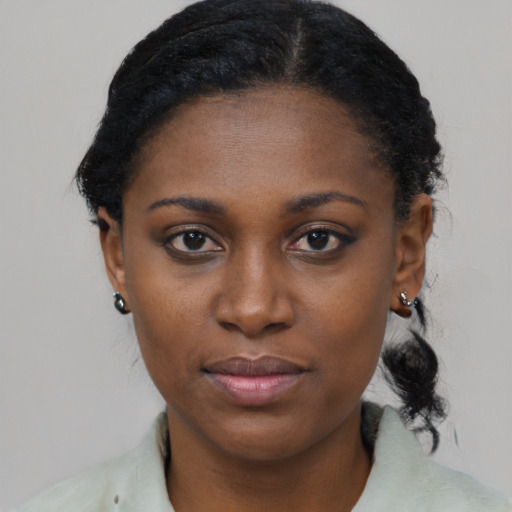 Joyful black young-adult female with medium  black hair and brown eyes