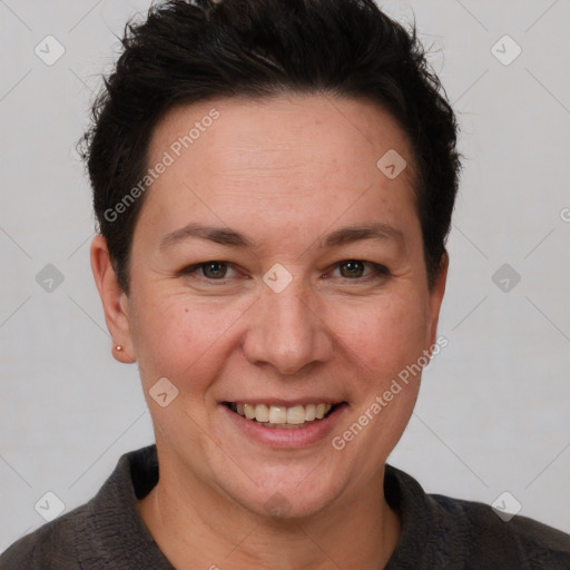 Joyful white adult female with short  brown hair and brown eyes