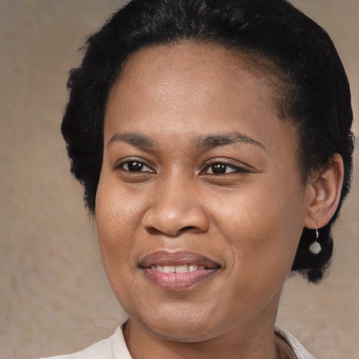Joyful black young-adult female with medium  black hair and brown eyes