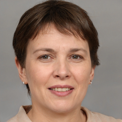 Joyful white adult female with medium  brown hair and grey eyes