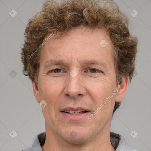 Joyful white adult male with short  brown hair and grey eyes